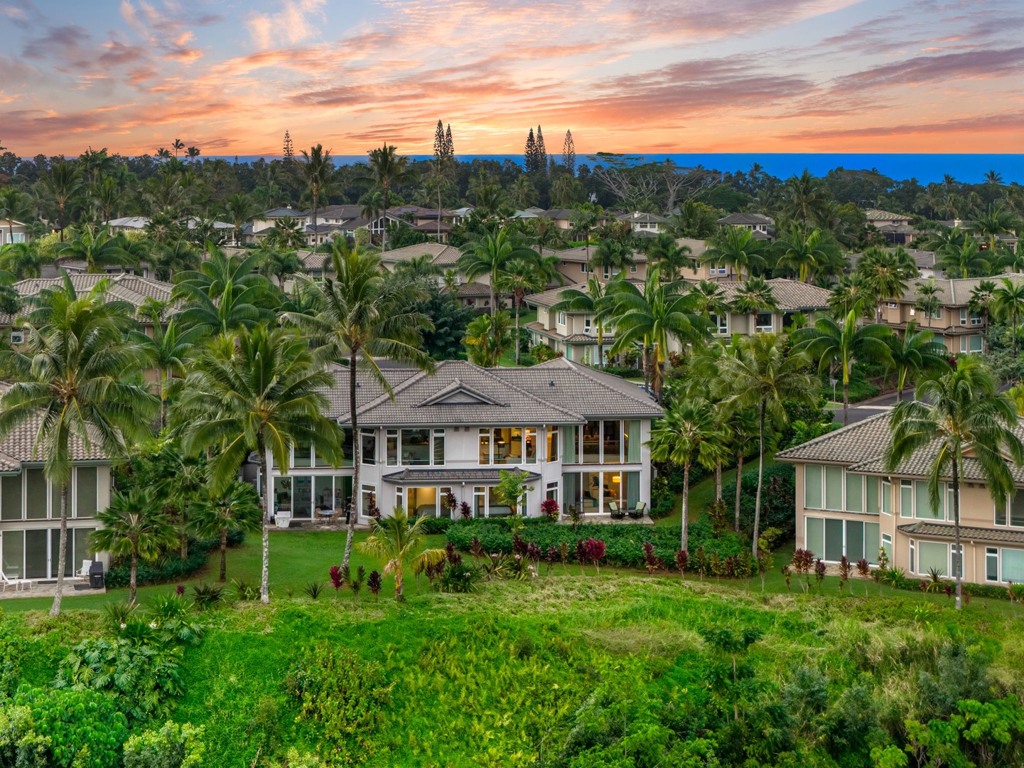 Princeville Vacation Rentals, Kaiulani #8 - Evenings end in pink and orange skies over the palms and rooftops of Kaiulani.