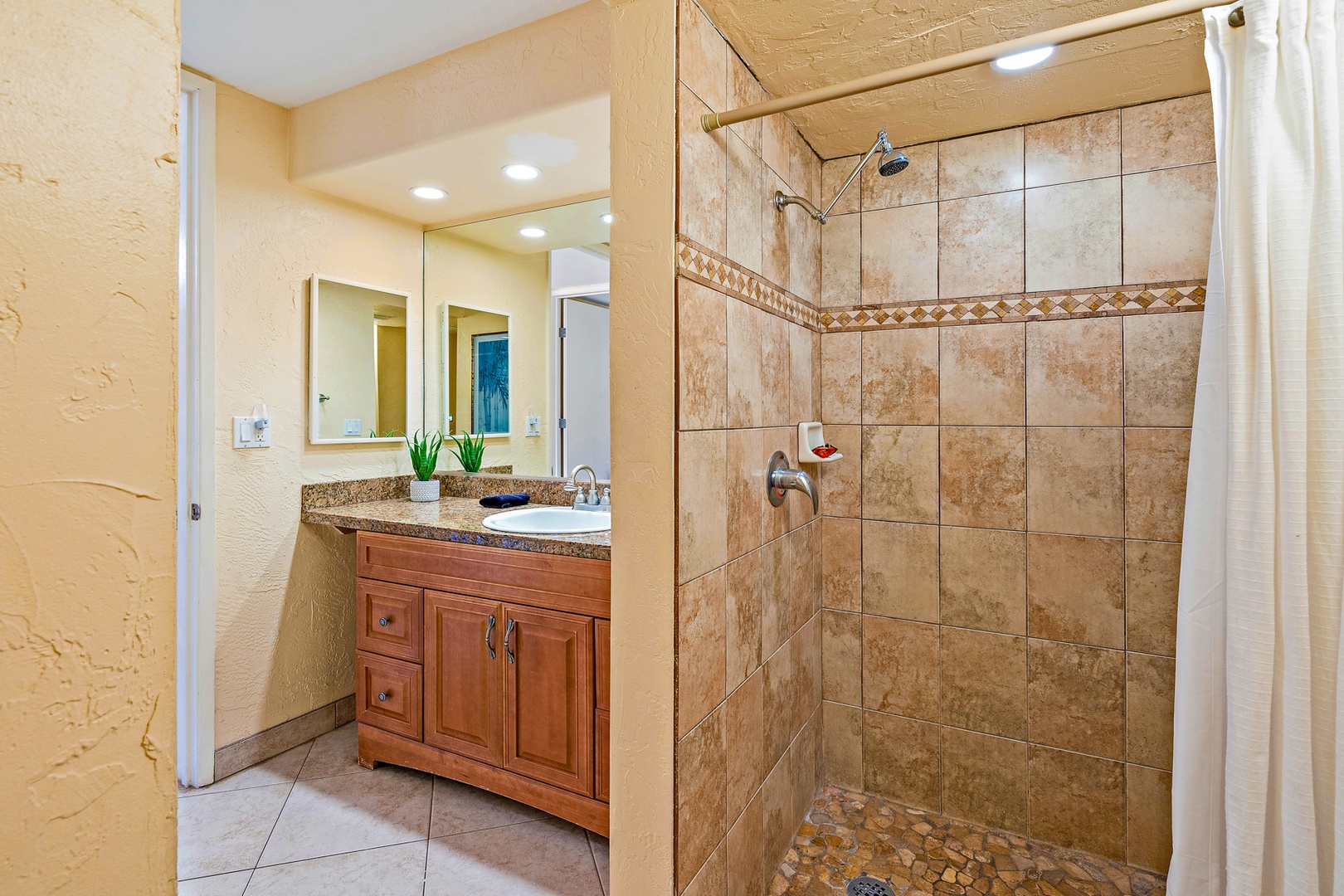 Lahaina Vacation Rentals, Papakea G-306 - The bathroom features a beautifully tiled walk-in shower and a spacious vanity, creating a relaxing and functional space for your daily routine.