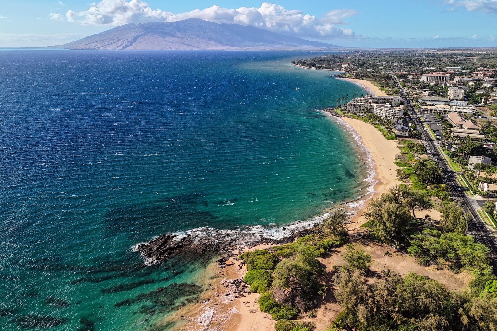 Kihei Vacation Rentals, Haleakala Shores A206 - The whole curve of the bay opens up from here, West Maui's mountains rising behind the shoreline.