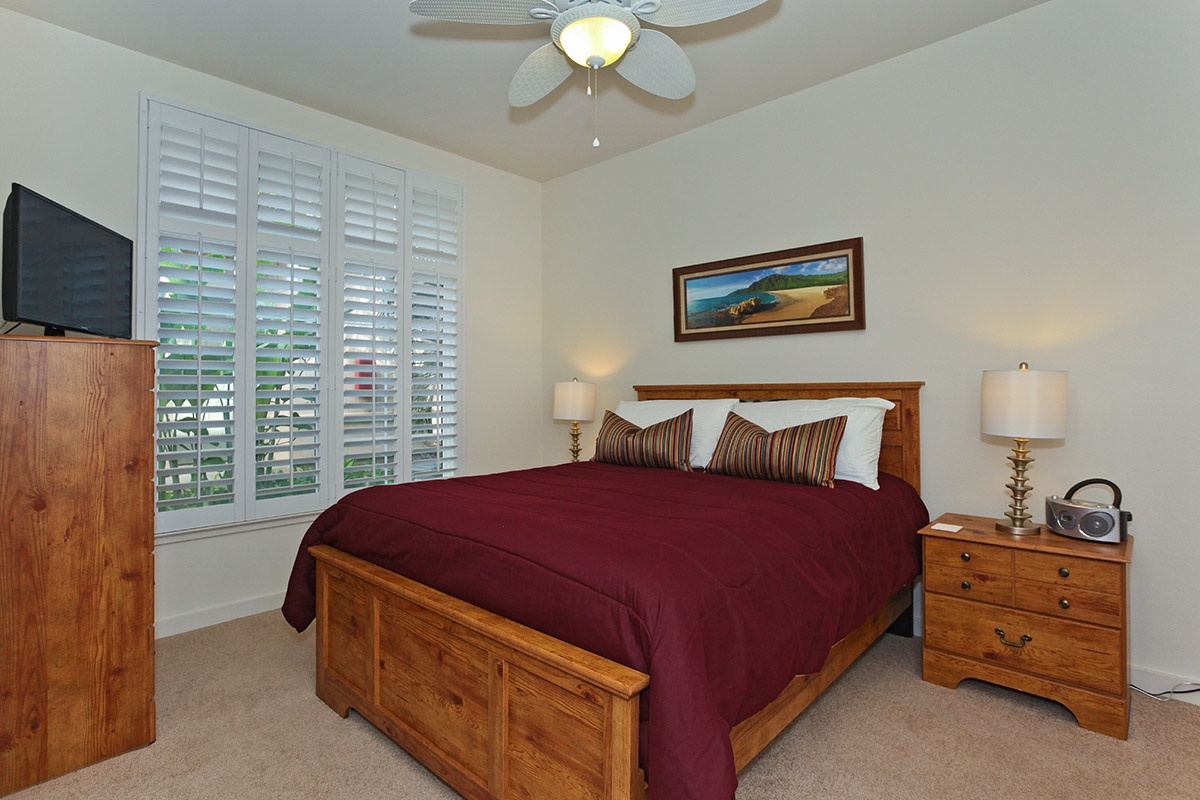 Kapolei Vacation Rentals, Kai Lani 12D - The second guest bedroom with a dresser for storage and framed art.