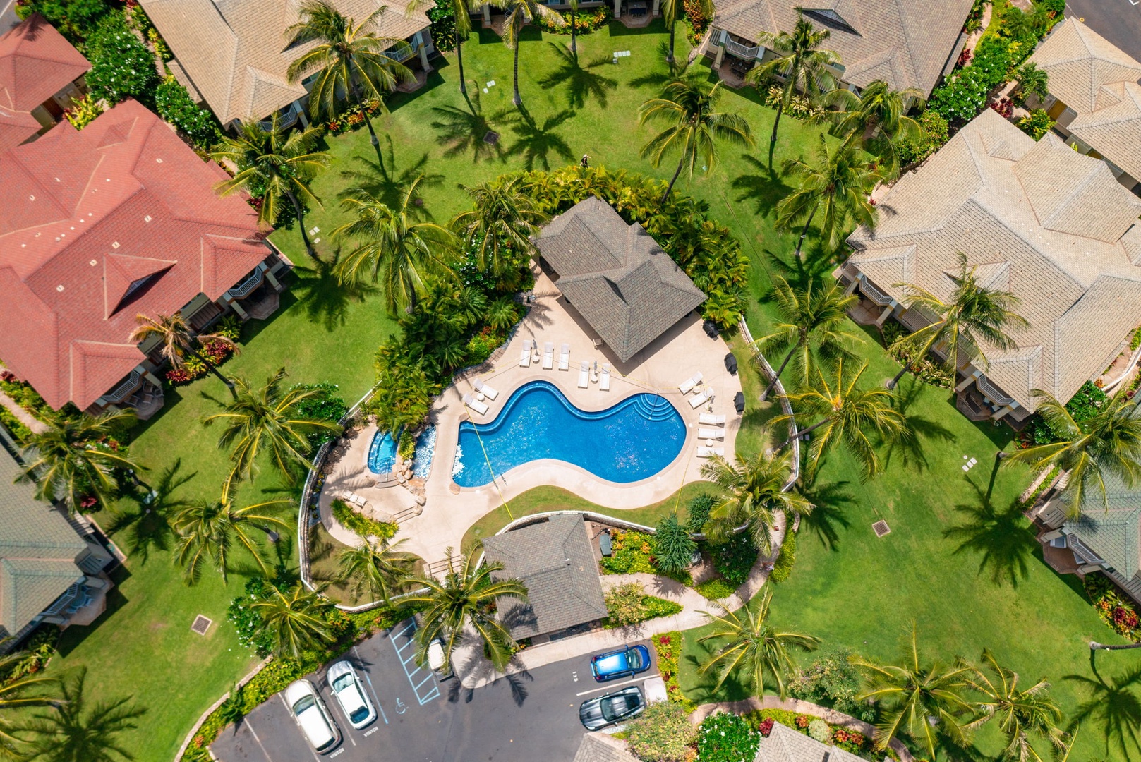 Kapolei Vacation Rentals, Kai Lani Luxury 6D - Overhead view of the Kai Lani pool and clubhouse area, nestled within lush greenery and palm trees.