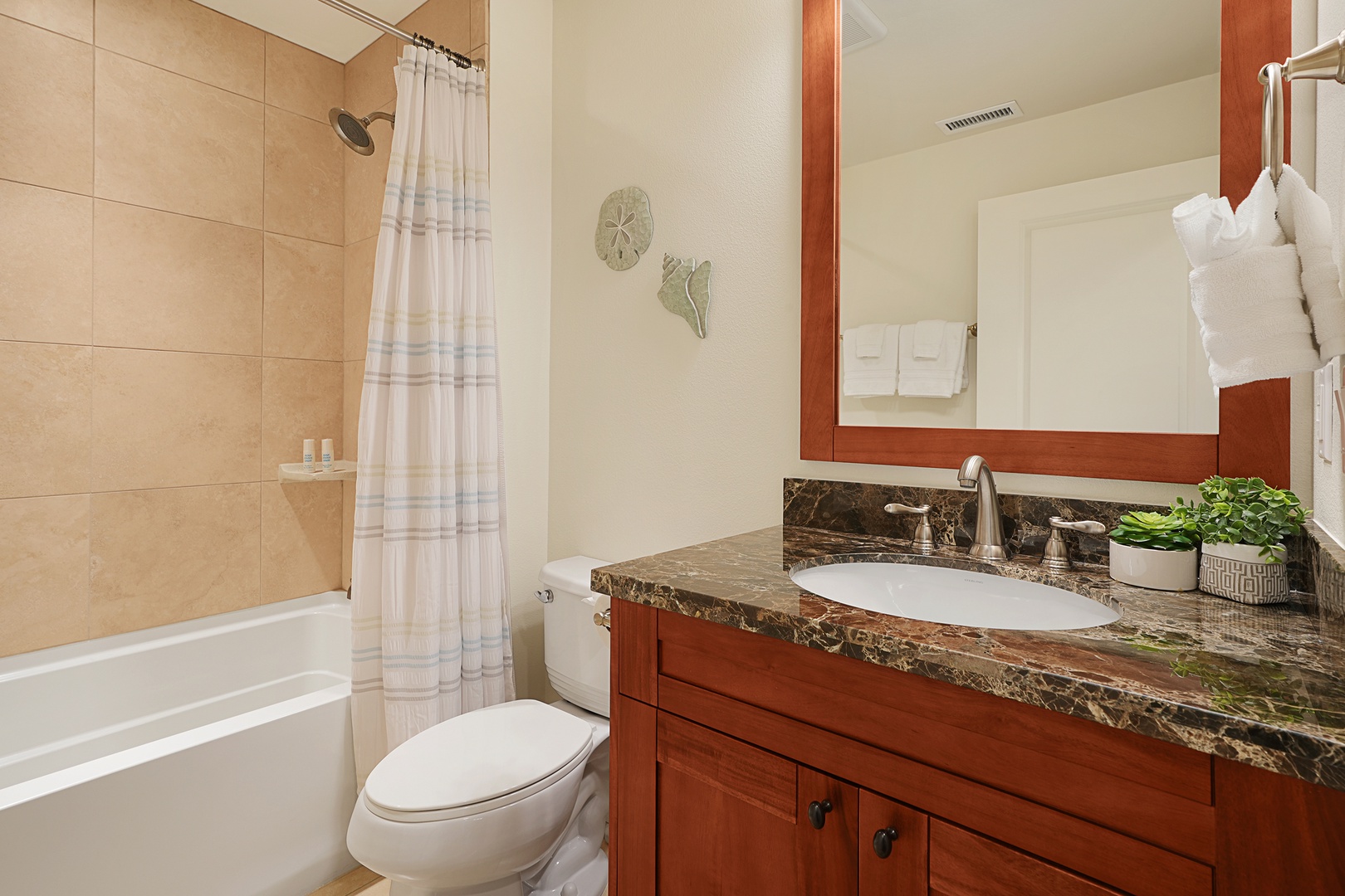 Koloa Vacation Rentals, Pili Mai 6J - Your private bathroom features a relaxing tub-shower combo and elegant granite countertop with fresh amenities waiting.