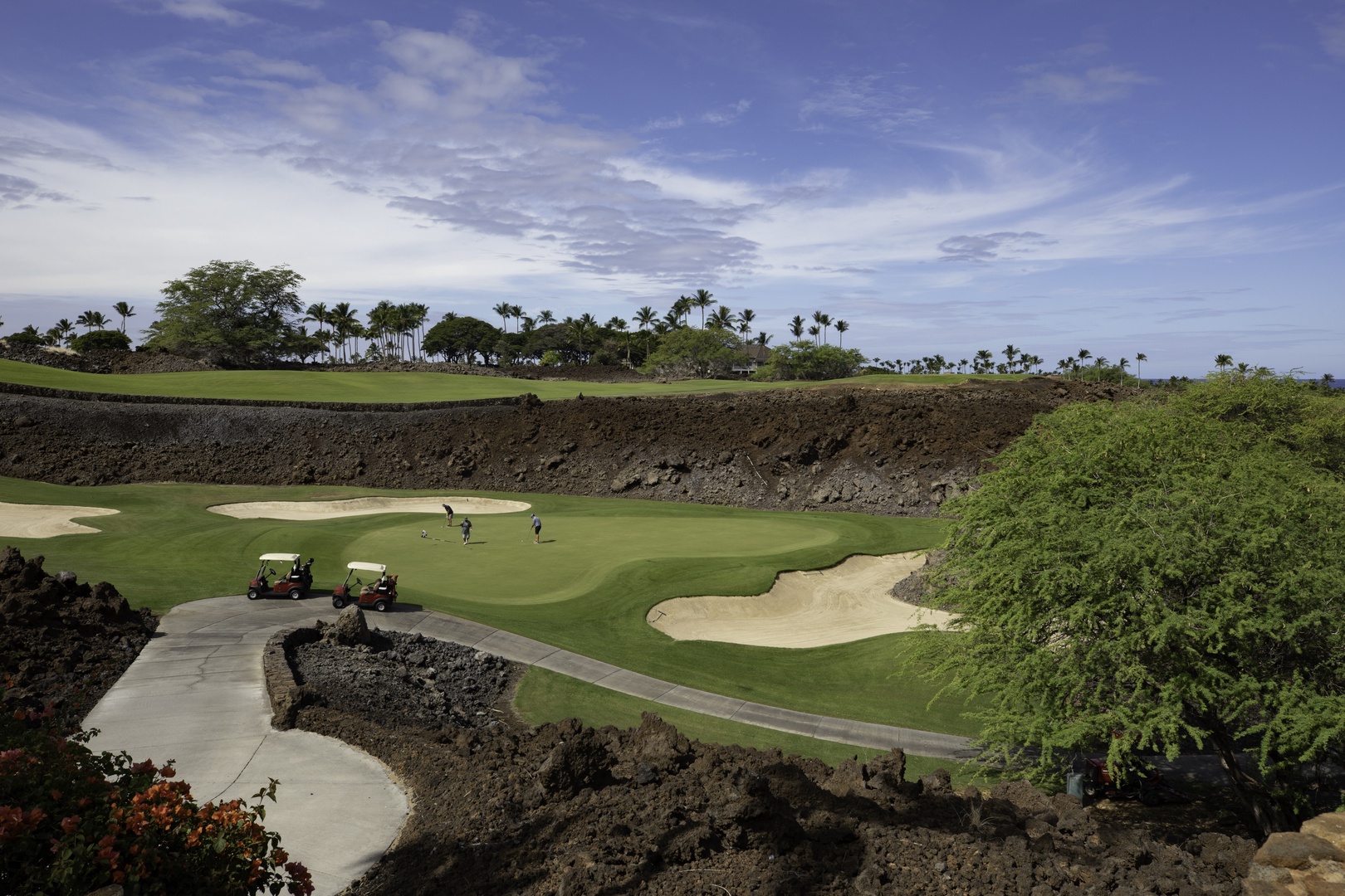 Kamuela Vacation Rentals, Champion Ridge 7 - Championship golf course with dramatic volcanic rock formations and palm-lined fairways beneath tropical skies.