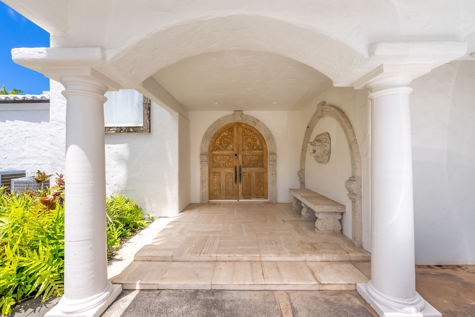 Kailua Vacation Rentals, Lanikai Sunrise Estate - Welcoming arched entry with warm wood doors and bench seating invites you into your private retreat.