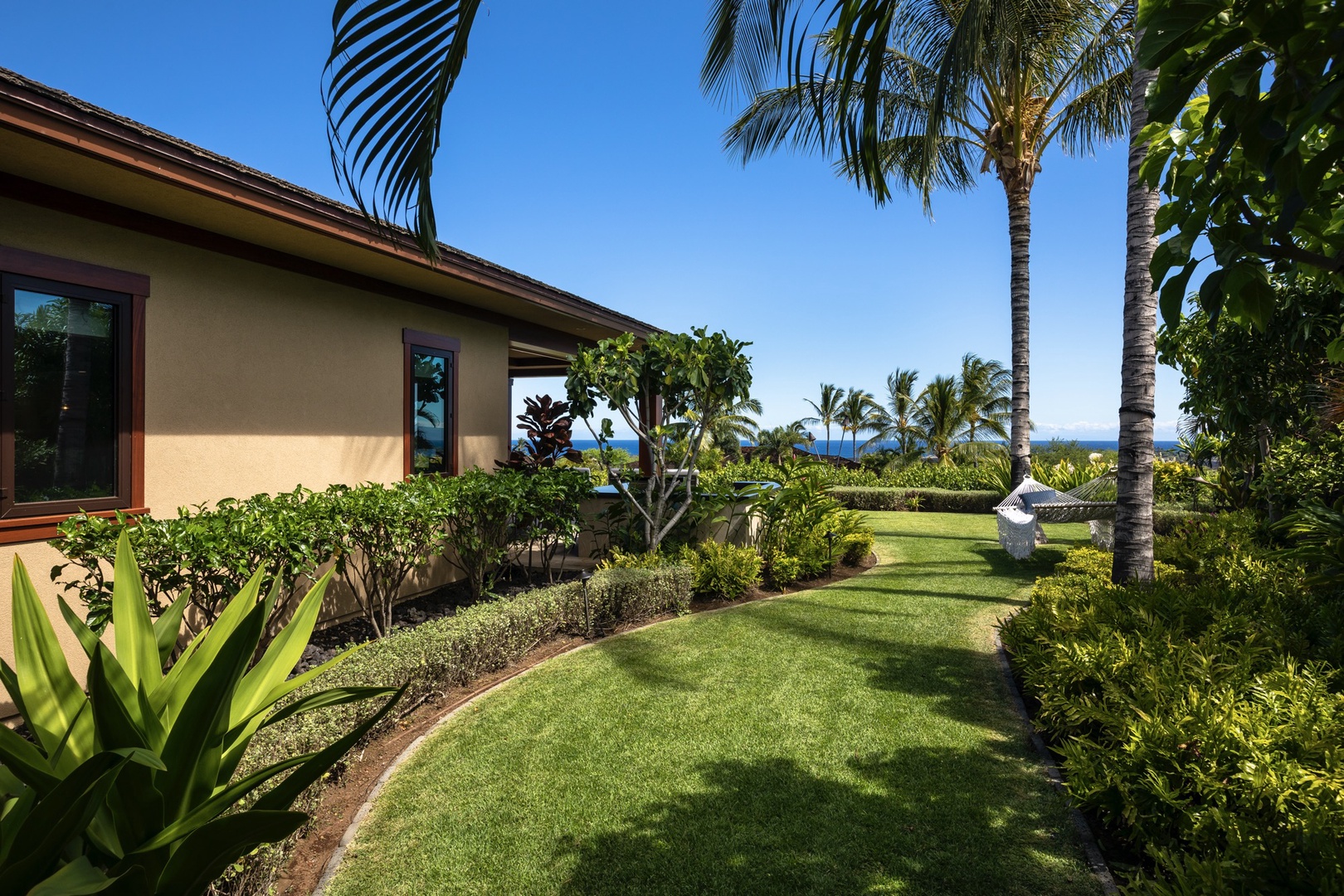 Kailua Kona Vacation Rentals, 4BD Kulanakauhale Estate (3558) at Hualalai Resort - Closer view of side yard off guest bedroom two with hammock and ocean beyond.