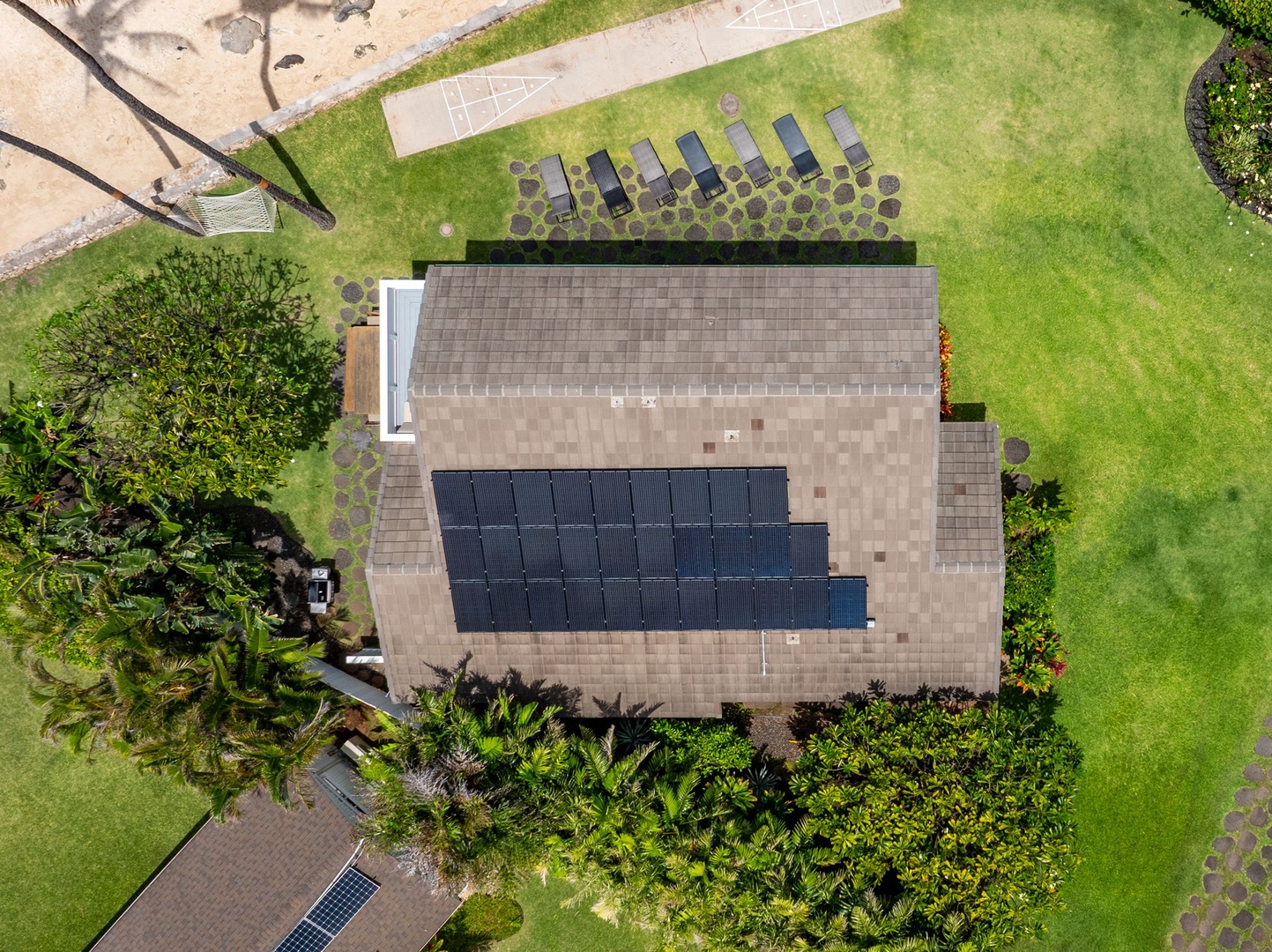 Waianae Vacation Rentals, Ma'ili Blue - Solar-powered property featuring eco-friendly energy solutions and spacious landscaped grounds with tropical vegetation and recreational amenities.