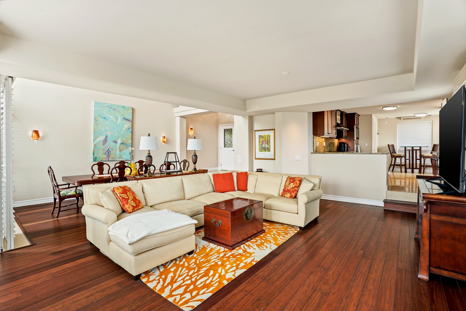Princeville Vacation Rentals, Hale Hau'oli Moku - Sink into the wraparound sectional, where the living room opens straight through to the kitchen.