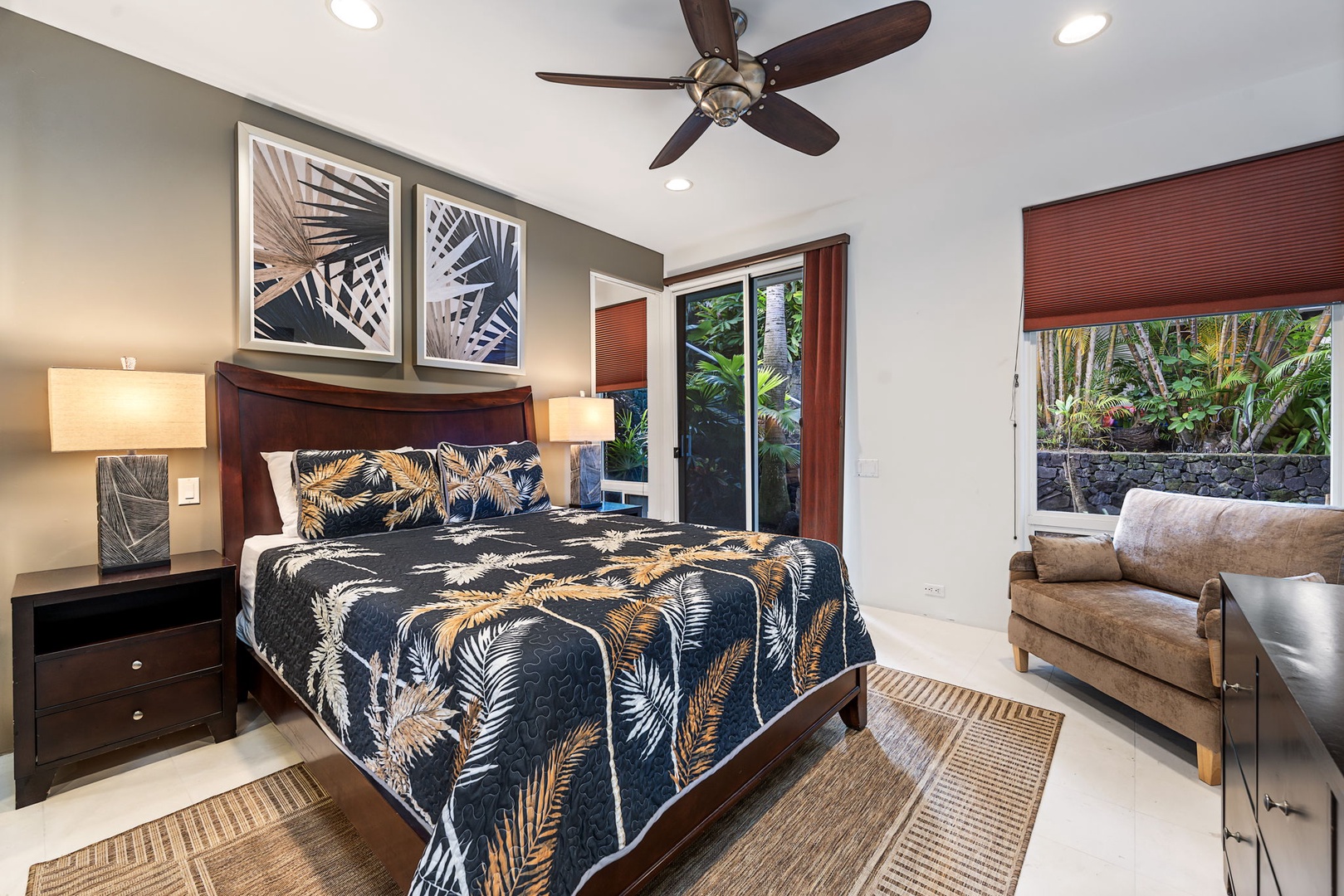 Kailua Kona Vacation Rentals, Hale Nai'a - Unwind in your tropical-themed bedroom featuring a ceiling fan, plush furnishings, and serene garden views through your private windows.