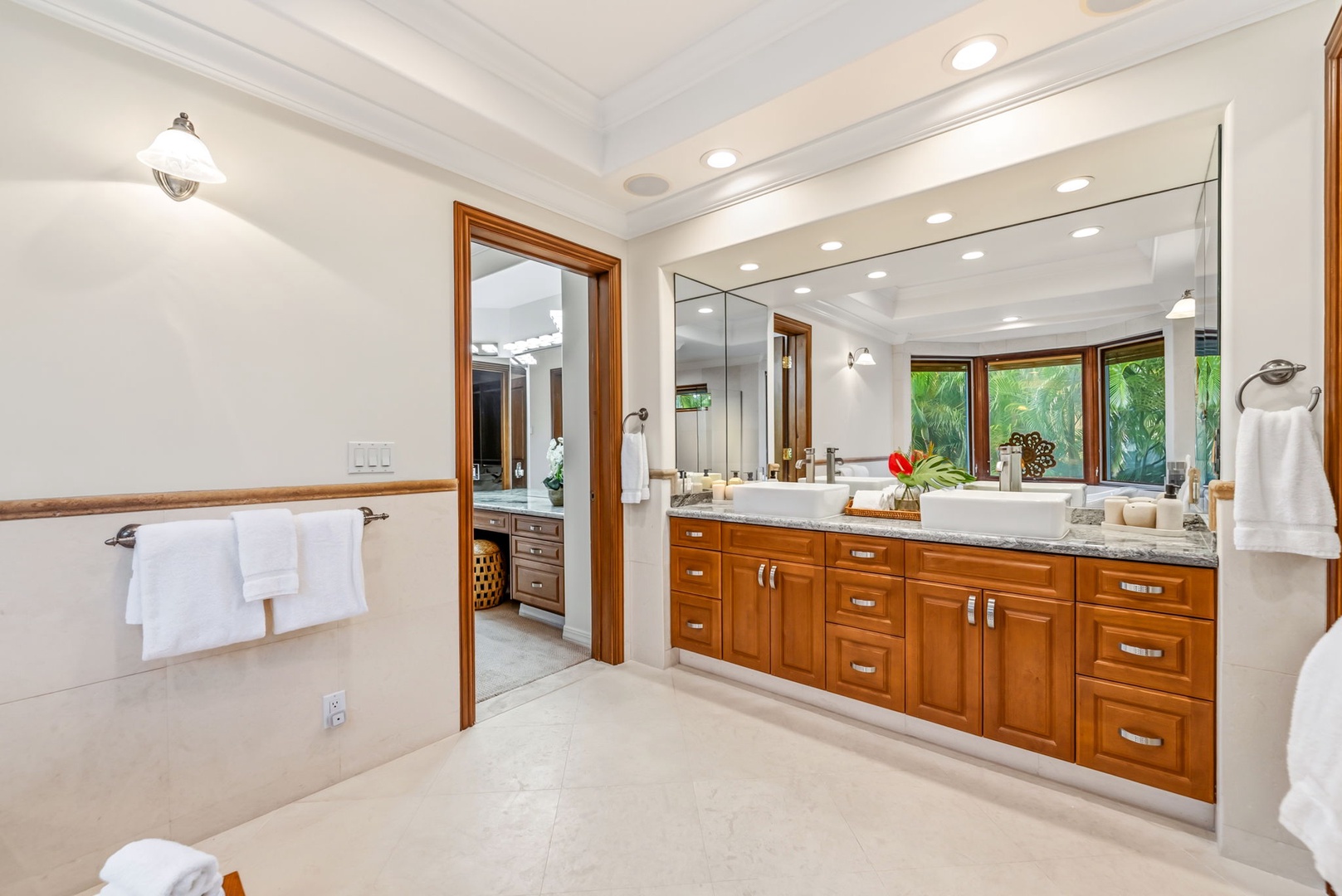 Honolulu Vacation Rentals, Maunalua Estate - Dual vanities, warm wood cabinetry, and soft lighting create a bright, polished ensuite.