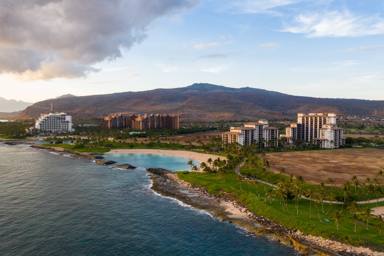 Kapolei Vacation Rentals, Ko Olina Beach Villas B109 - The lagoon curls into the coastline below the villas, the mountains rising behind.