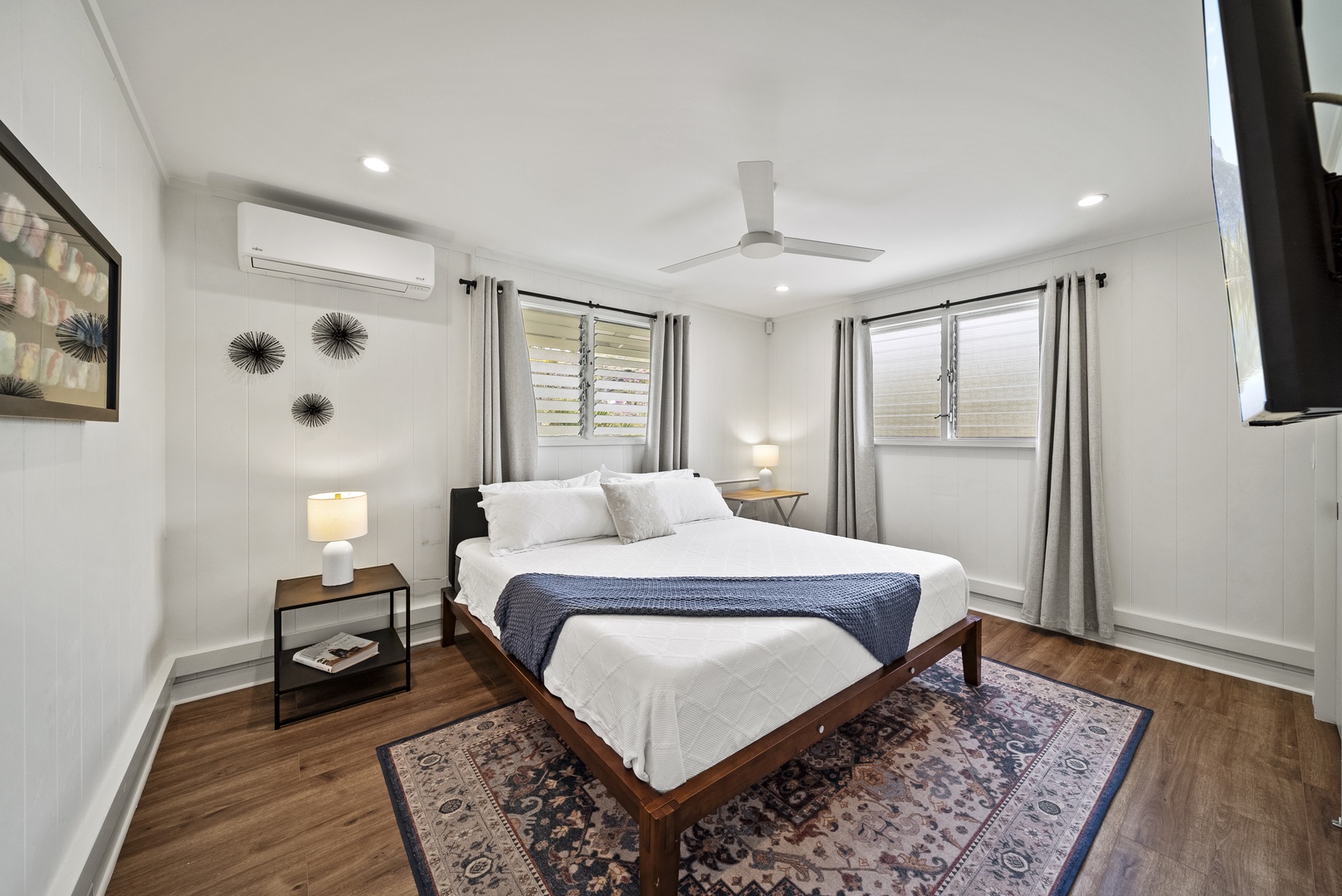 Honolulu Vacation Rentals, Honolulu Beachfront Retreat - Guest suite with a king bed, minimalist décor, and natural light creating a cozy, inviting atmosphere.