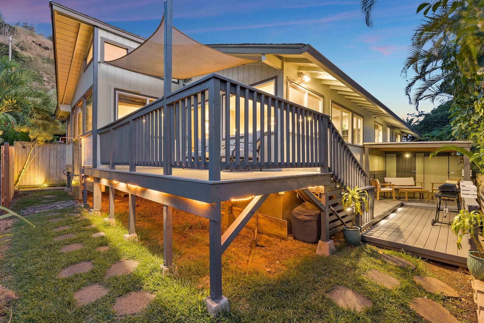 Haleiwa Vacation Rentals, Velzey Ohana Villa (4B Vacation Home) - Evening glow highlights the raised deck and lush greenery—your own tropical treehouse escape.