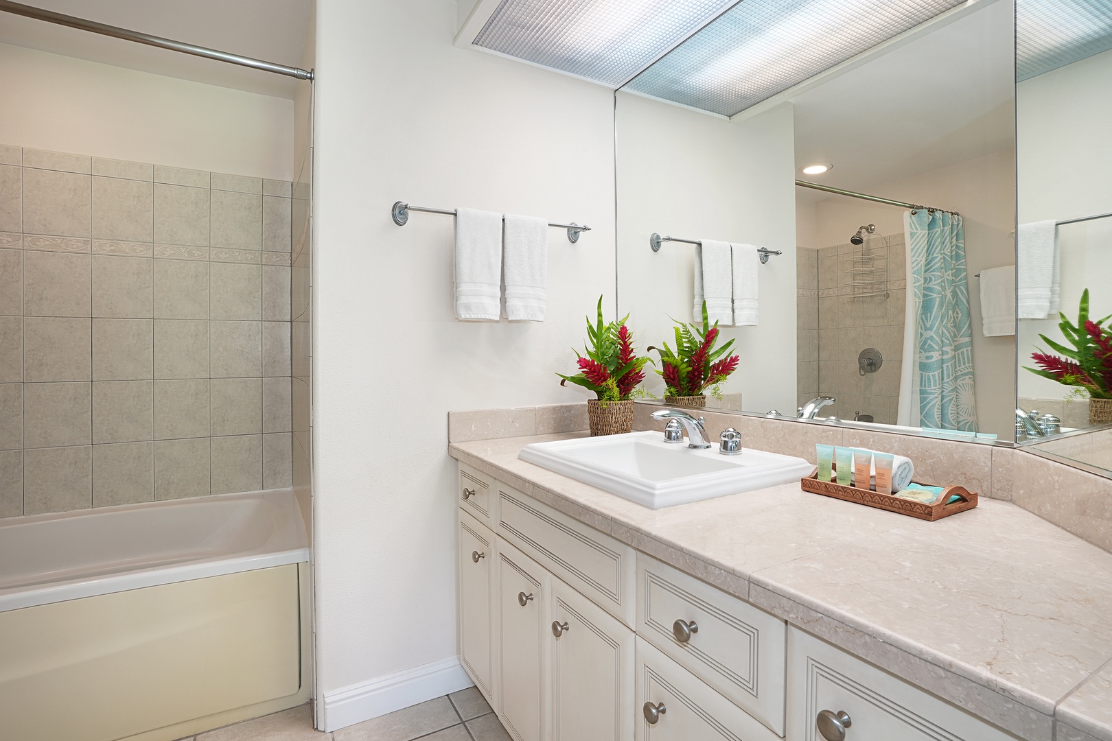 Princeville Vacation Rentals, Ku'u Lei Villa - The second primary bathroom offers a spacious vanity and a refreshing shower, creating a spa-like experience.
