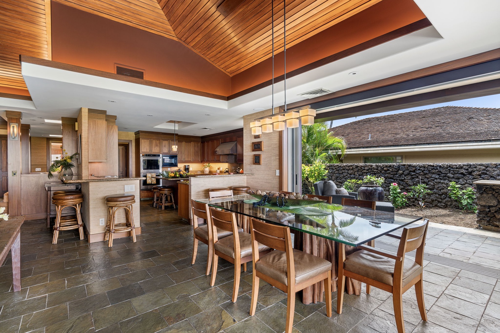 Kailua Kona Vacation Rentals, 3BD Pakui Street Estate (149) at Hualalai Resort - Glass-topped dining for the whole group, doors open to the garden alongside.