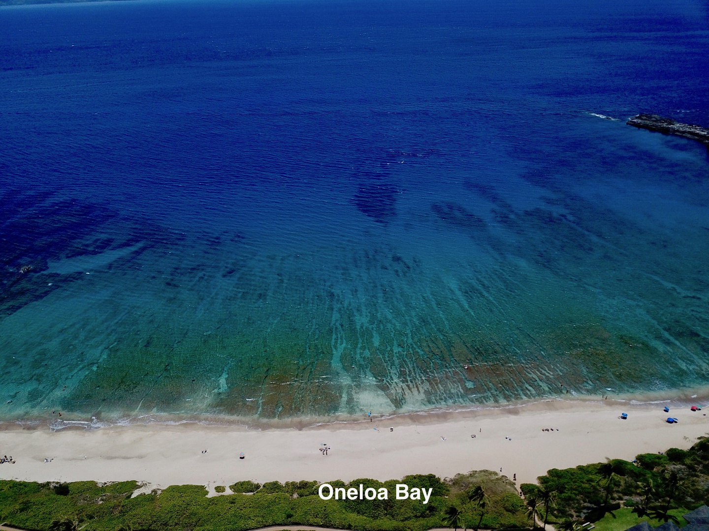 Lahaina Vacation Rentals, Kapalua Ridge 1622 - A breathtaking aerial view of Oneloa Bay, with its crystal-clear waters and sandy shoreline, perfect for a relaxing day at the beach.