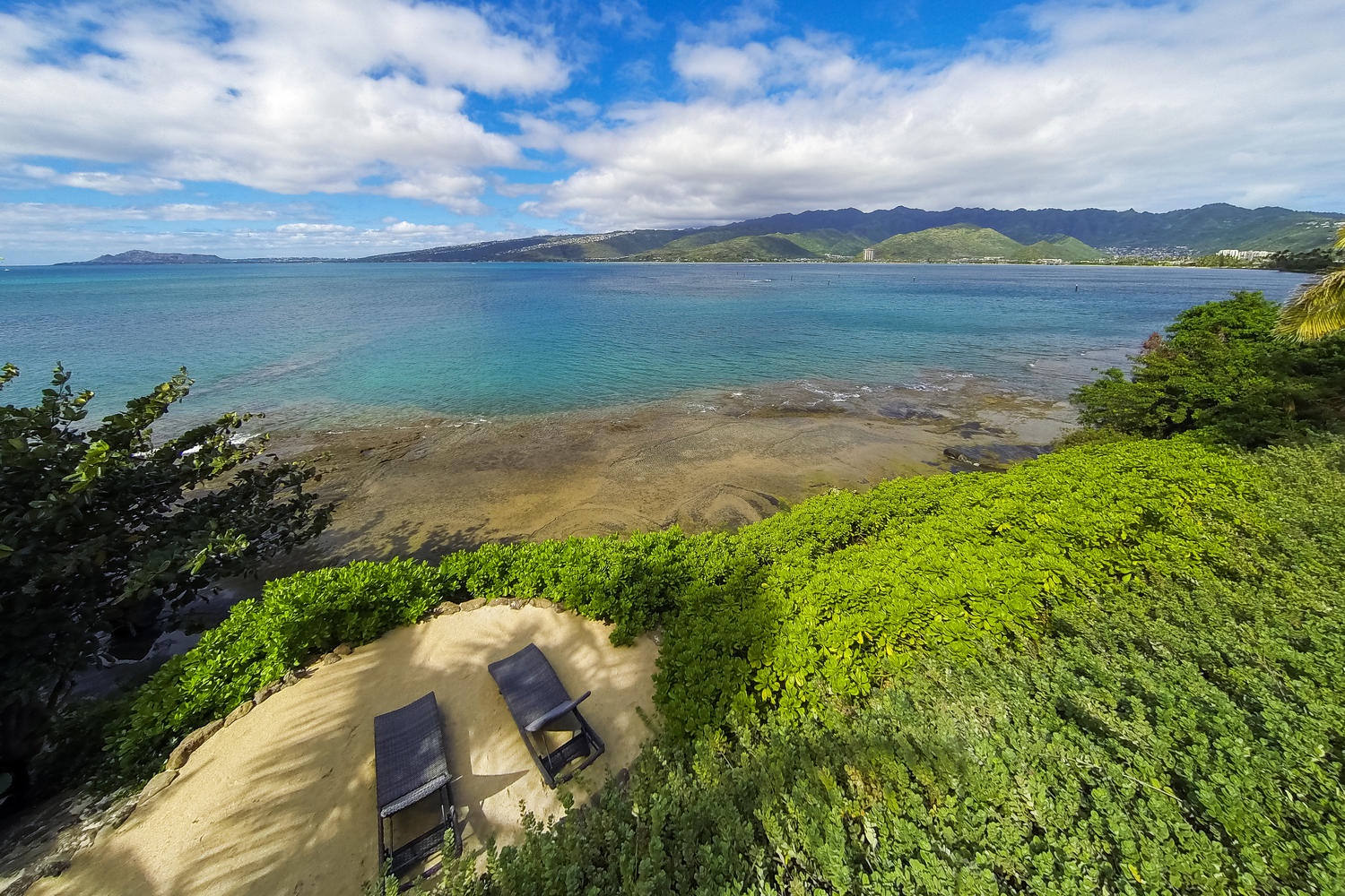 Honolulu Vacation Rentals, Ocean House - Sand terrace with chaise lounge chairs.