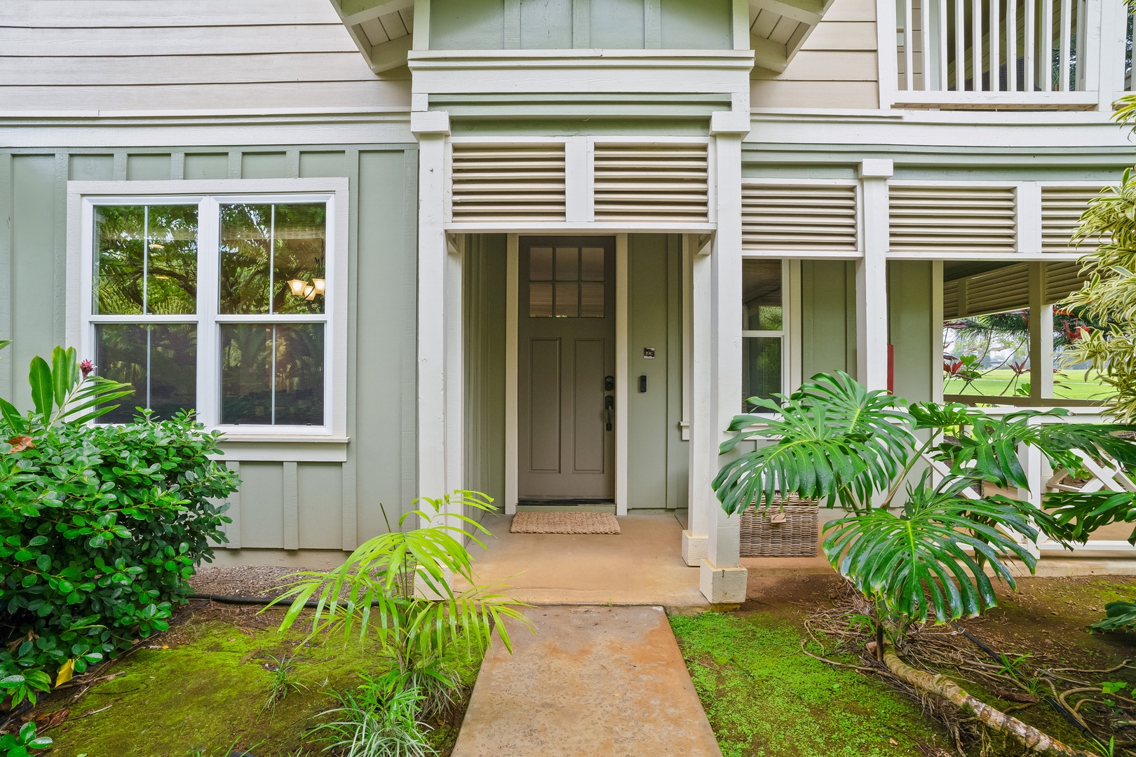 Princeville Vacation Rentals, Hale Kaua'i - Arrive to lush greenery, soft island colors, and a warm, welcoming entrance experience.