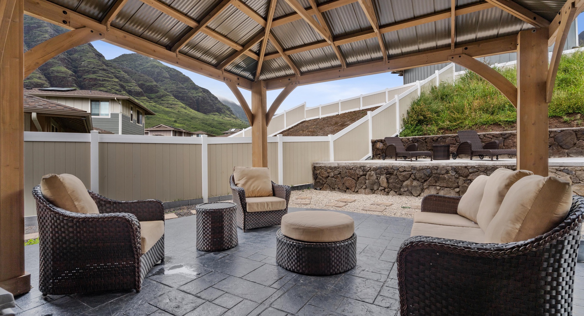 Makaha Valley Vacation Rentals, Makaha Valley Hale Kai** - Shaded lounge with cushioned seating, a cozy spot for coffee or cocktails.