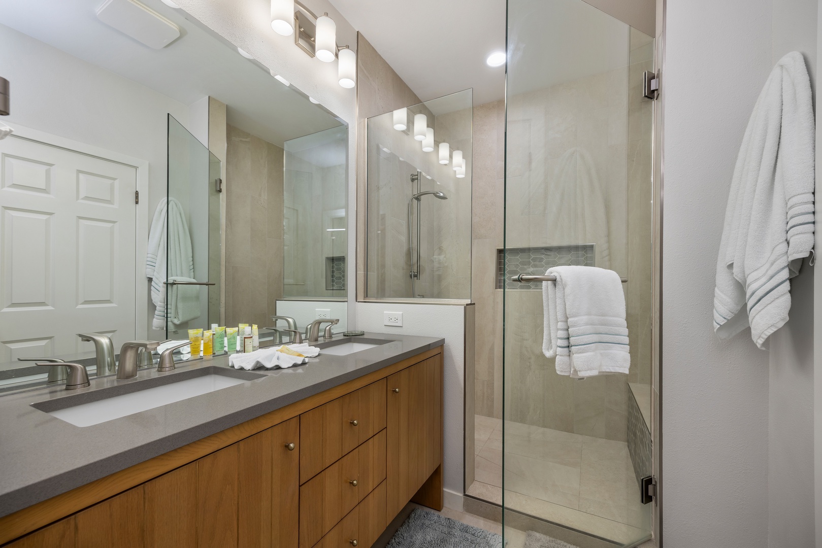 Refresh yourself in your stylish ensuite with dual sinks, spacious glass shower, and plush towels waiting.