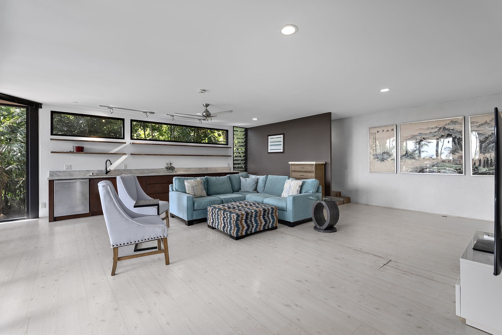 Honolulu Vacation Rentals, Tantalus Glass House (3 BD) - Modern open-plan space where sleek kitchen flows into comfortable lounge with garden views through floor-to-ceiling windows.