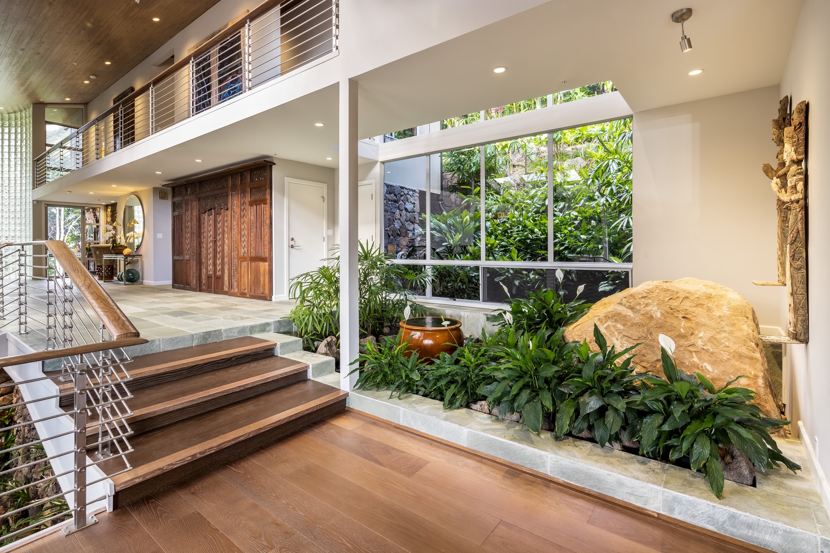 Honolulu Vacation Rentals, Manoa Royal Retreat - Striking entry with lush indoor landscaping and sleek architectural lines—your luxurious welcome.