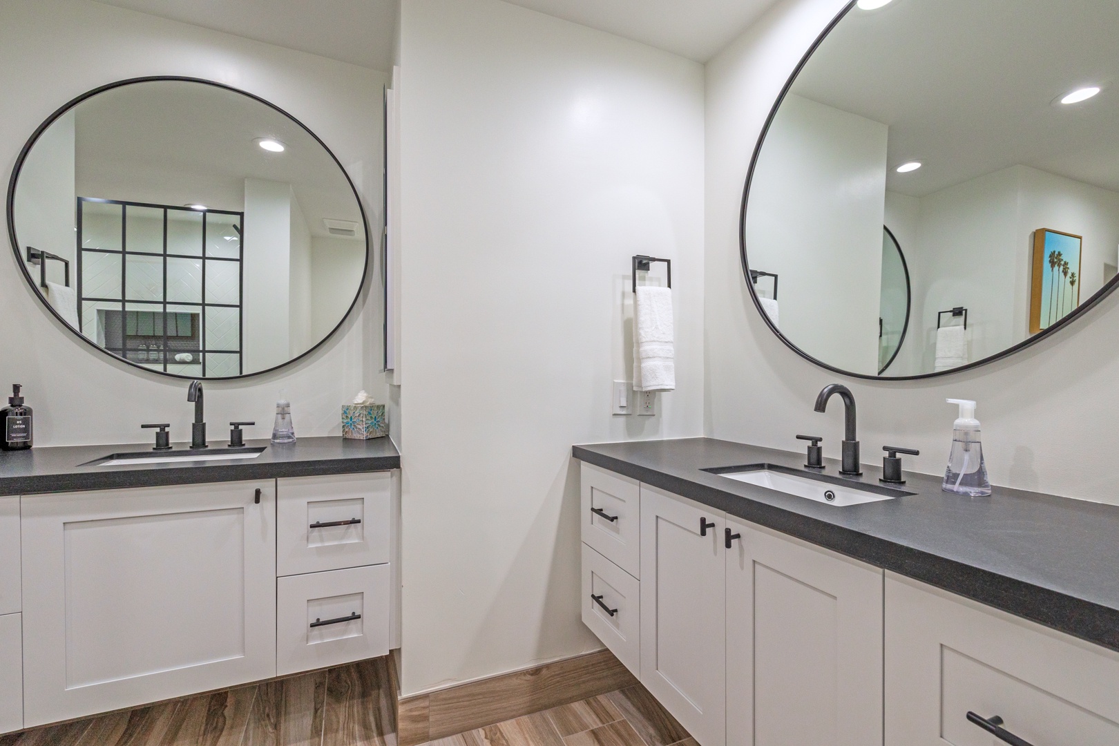 Lahaina Vacation Rentals, Kapalua Ridge 1421 - This double vanity bathroom features sleek black fixtures and large round mirrors, creating a modern and functional space for getting ready