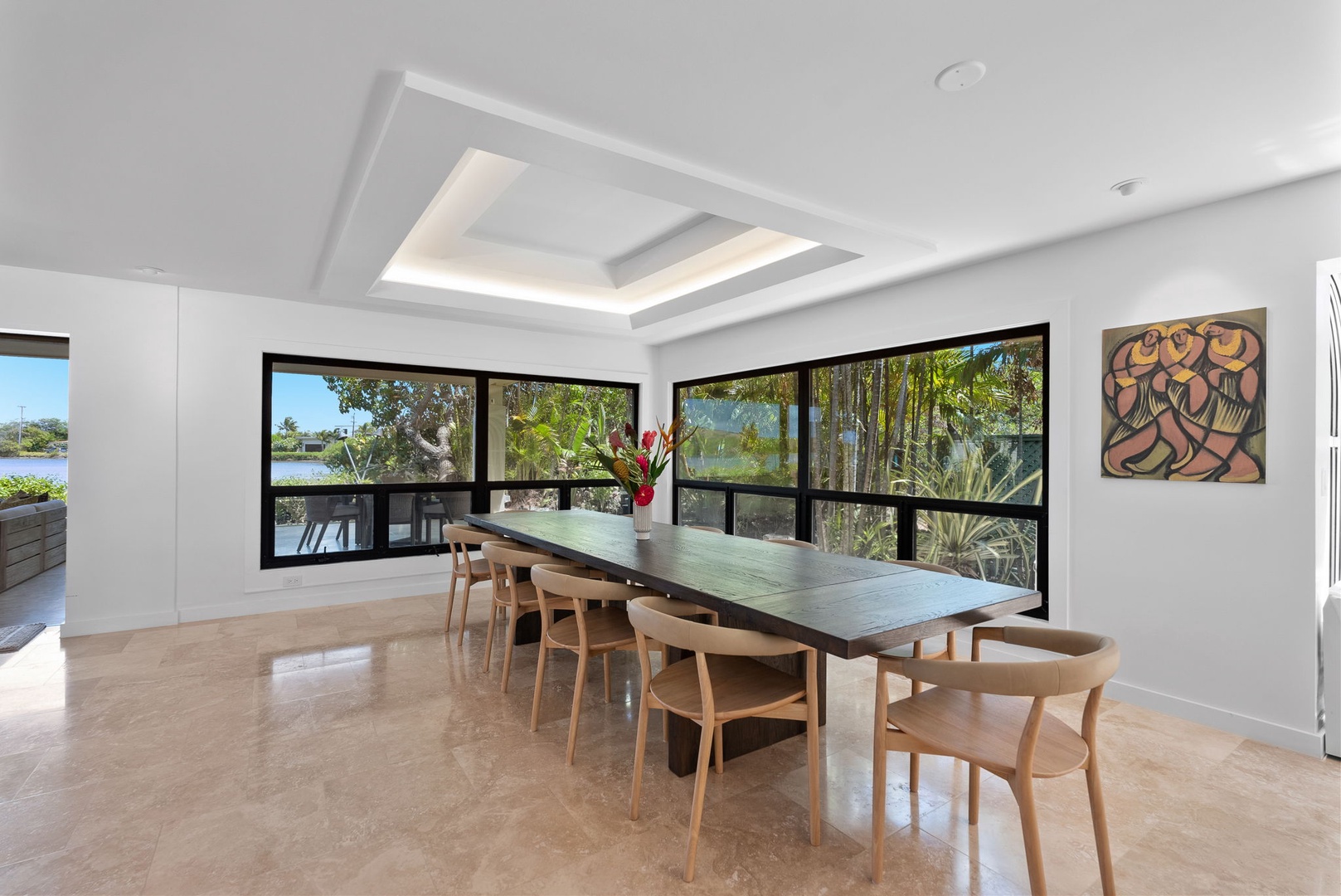 Honolulu Vacation Rentals, Honolulu Lagoonfront Villa - Dine with a view at Honolulu Lagoonfront Villa—oversize windows frame lush tropical surroundings in this elegant dining space.