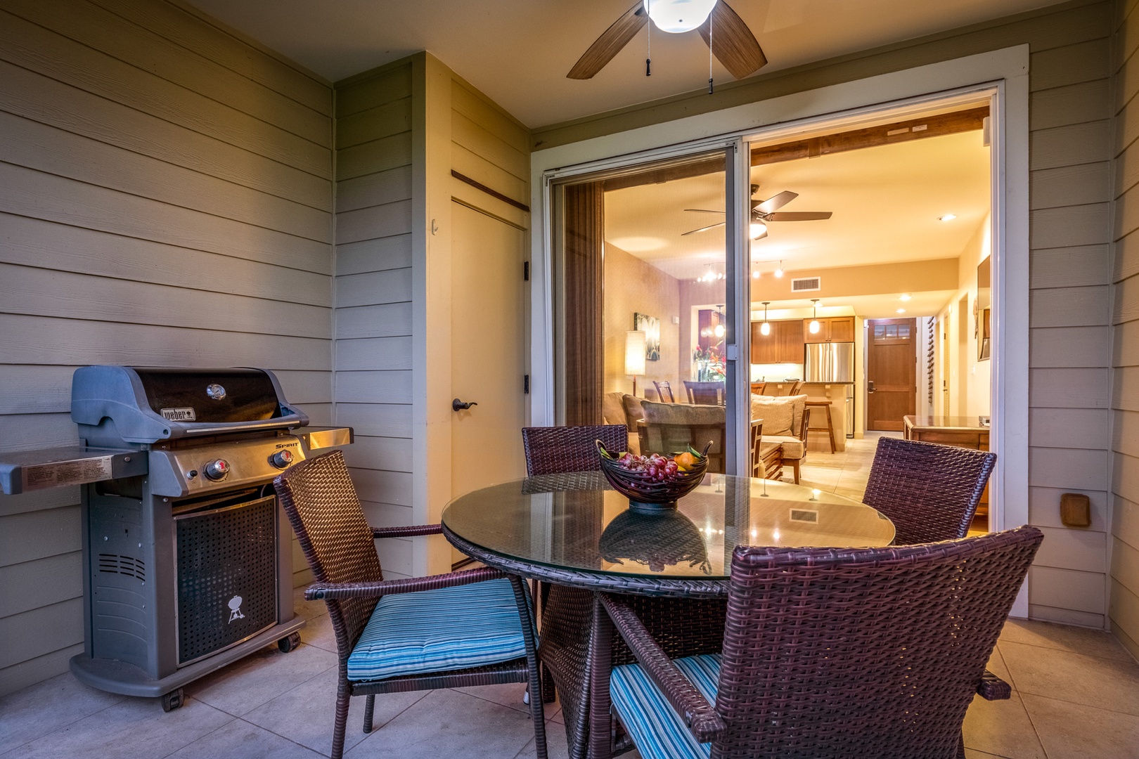 Waikoloa Vacation Rentals, 2BD Hali'i Kai (12C) at Waikoloa Resort - Outdoor dining space on the lanai at twilight with view into the condo.