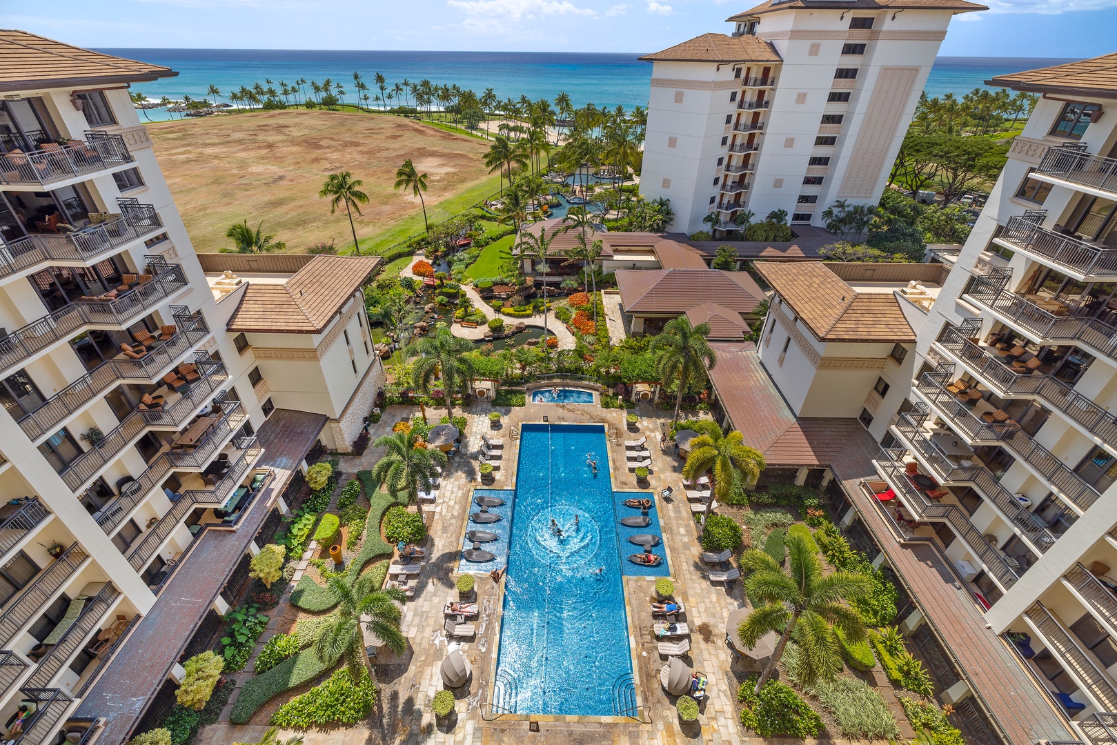 Kapolei Vacation Rentals, Ko Olina Beach Villas O1004 - Resort pool view from the lanai with a glimpse of the ocean