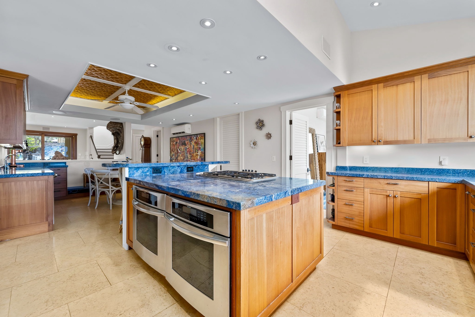 Kailua Vacation Rentals, Leaf House - You'll love cooking in this spacious kitchen with its stunning blue countertops, large center island with gas range, double ovens, and warm wood cabinetry that invites your culinary creativity.