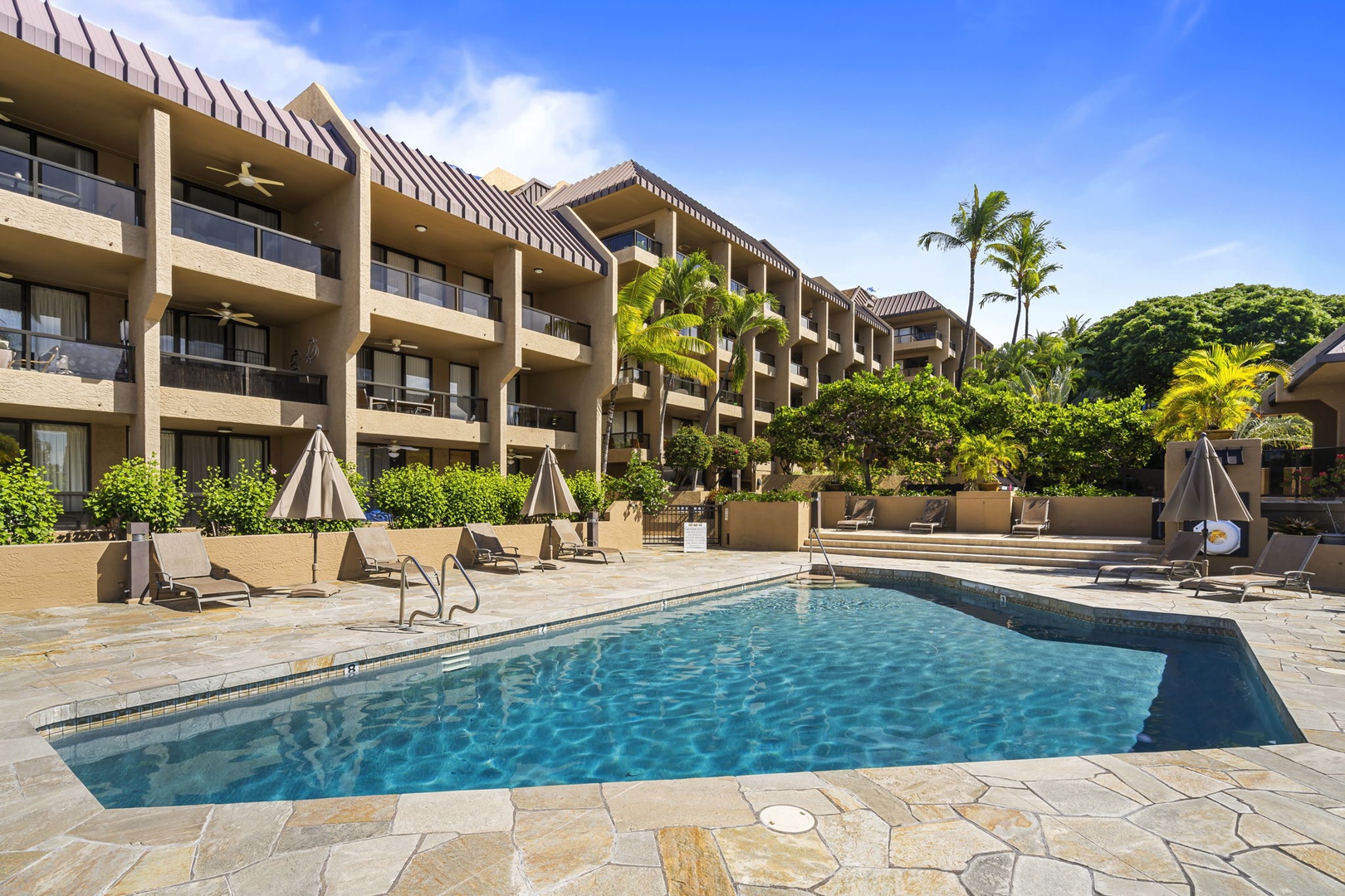 Kailua Kona Vacation Rentals, Kona Pacific C416 - Well-maintained pool deck with plenty of seating for soaking up the sun