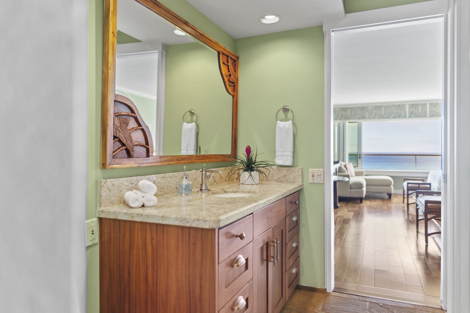 Honolulu Vacation Rentals, Hale Kaimana Breeze - Powder room with elegant wooden cabinetry and ocean accents.