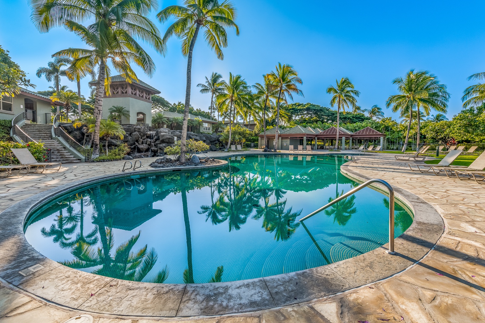 Kamuela Vacation Rentals, Mauna Lani Fairways #204 - Mirror-like reflections and tropical palms frame this resort-style pool, offering a picturesque start or end to any day.