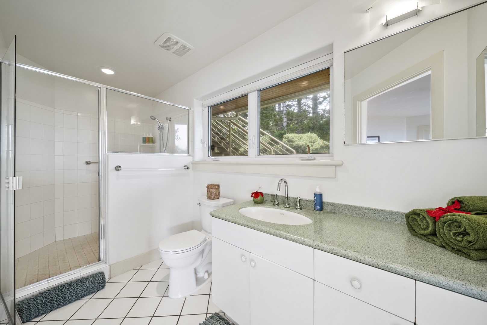 Haleiwa Vacation Rentals, Ka Hale Hau'oli - Step into your pristine ensuite bathroom featuring a spacious glass-enclosed shower and thoughtful touches like fresh towels awaiting your arrival.
