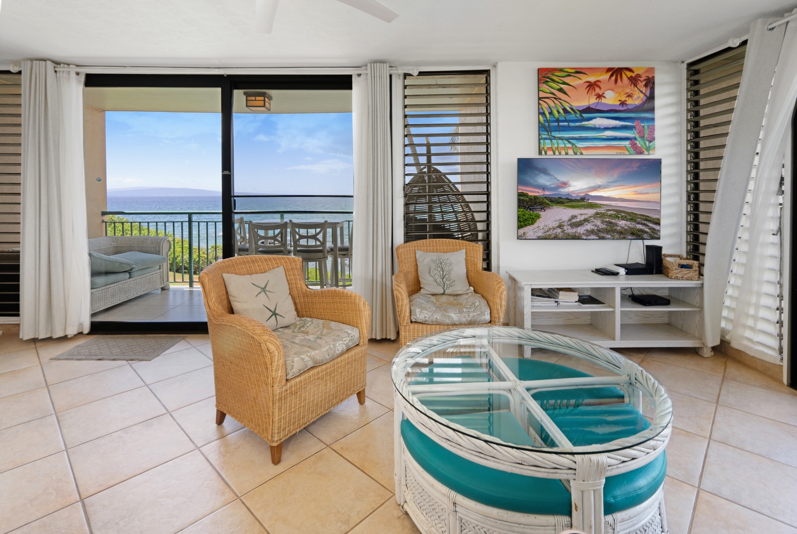Kihei Vacation Rentals, Punahoa Beach 205 - Settle into the rattan armchairs for an unhurried afternoon talk, with a glimpse of blue past the lanai rail.