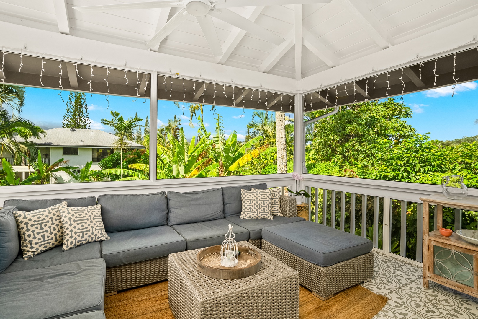 Princeville Vacation Rentals, Ola Hou - Main House - Gather on the lanai for intimate conversations with a backdrop of tropical greenery.