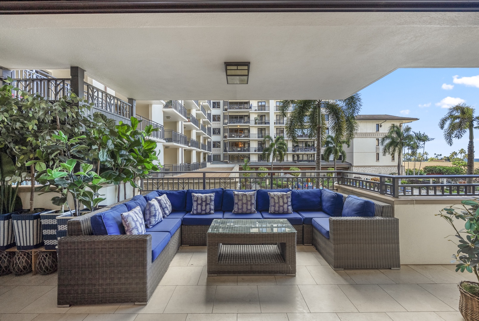Afternoons drift by on the lanai, the resort's palms filling the view past the rail.