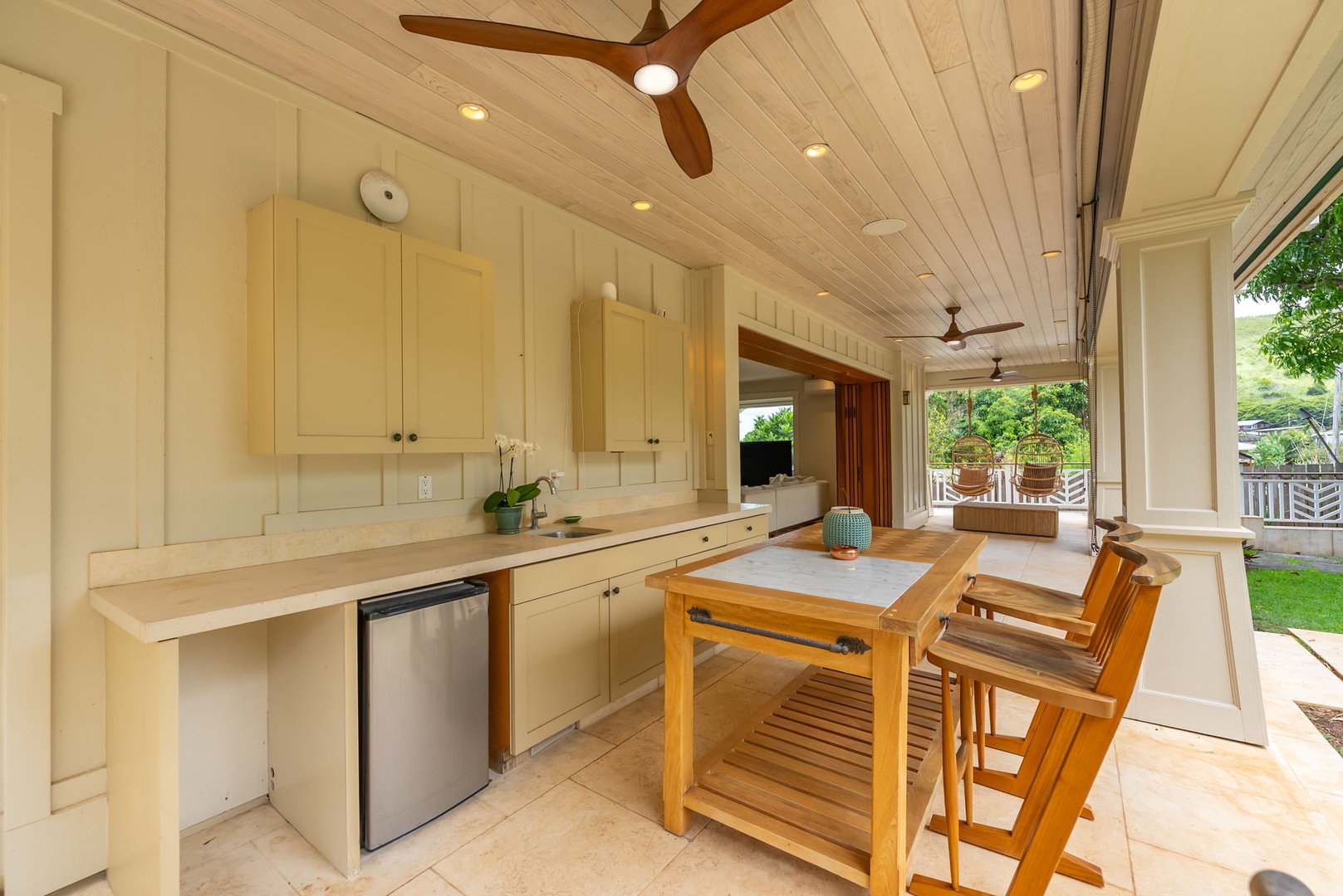 Kailua Vacation Rentals, Leaf House - Gather, cook, and entertain in your open-air kitchen, complete with cabinetry, counter space, and modern appliances. Ceiling fans keep you cool while you prep meals and enjoy seamless indoor-outdoor flow.