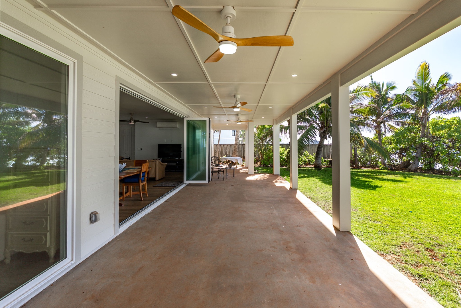 Waianae Vacation Rentals, Oceanfront Luxury Dream Estate - Sliding glass doors connect this breezy oceanfront lanai to the main living areas inside.