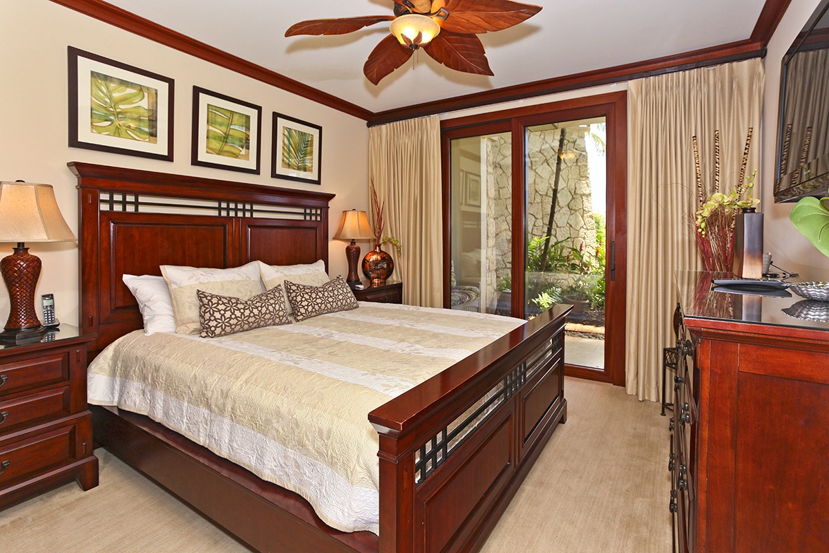Kapolei Vacation Rentals, Ko Olina Beach Villas B103 - The primary guest bedroom with direct access to the resort gardens.