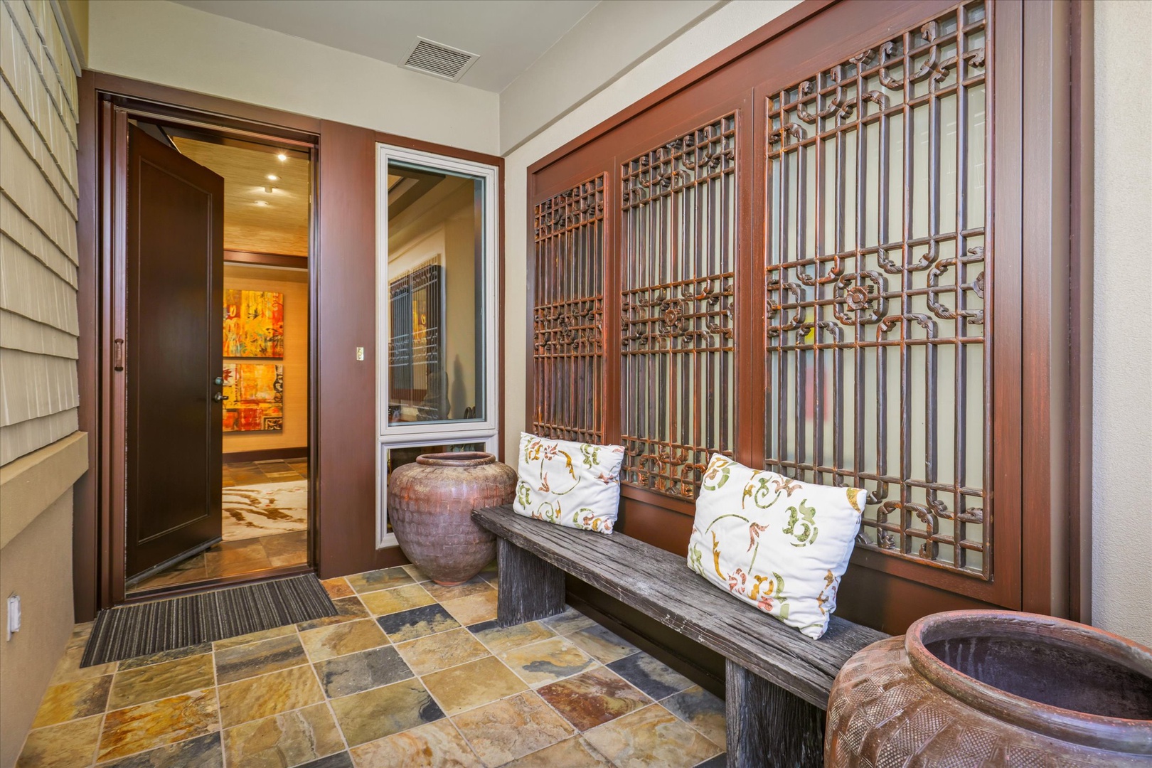 Kailua Kona Vacation Rentals, Wai'ulu Villa 115D - Custom carved wood paneling and seating greet guests in this artfully designed foyer space.