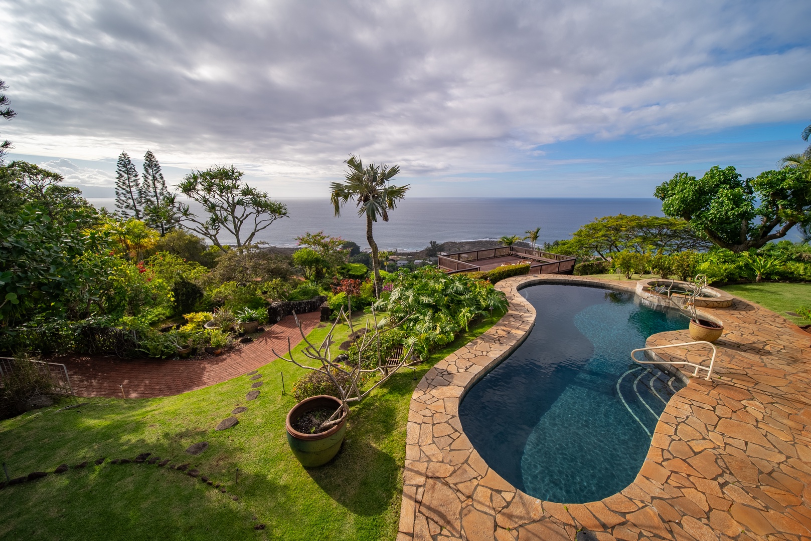 Haleiwa Vacation Rentals, Ka Hale Hau'oli - Elevated ocean view property featuring a curved swimming pool surrounded by lush tropical gardens with panoramic sea views.