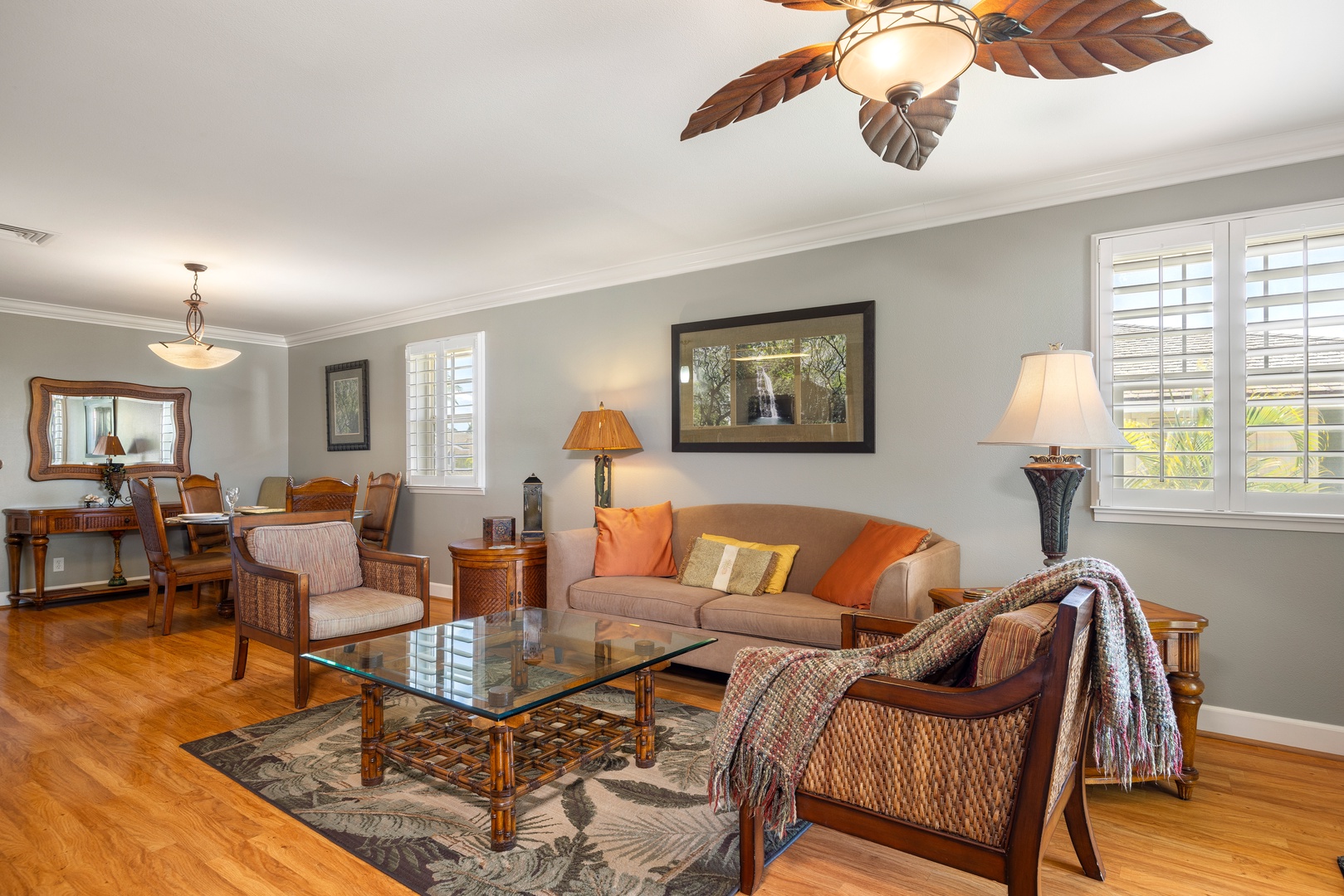 Sink into comfortable seating surrounded by tropical-inspired decor and warm wood tones in your elegant living space.