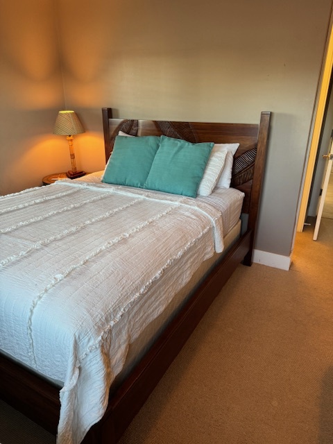 Princeville Vacation Rentals, Pili Aloha - Guest bedroom with a queen-size bed and warm ambiance.