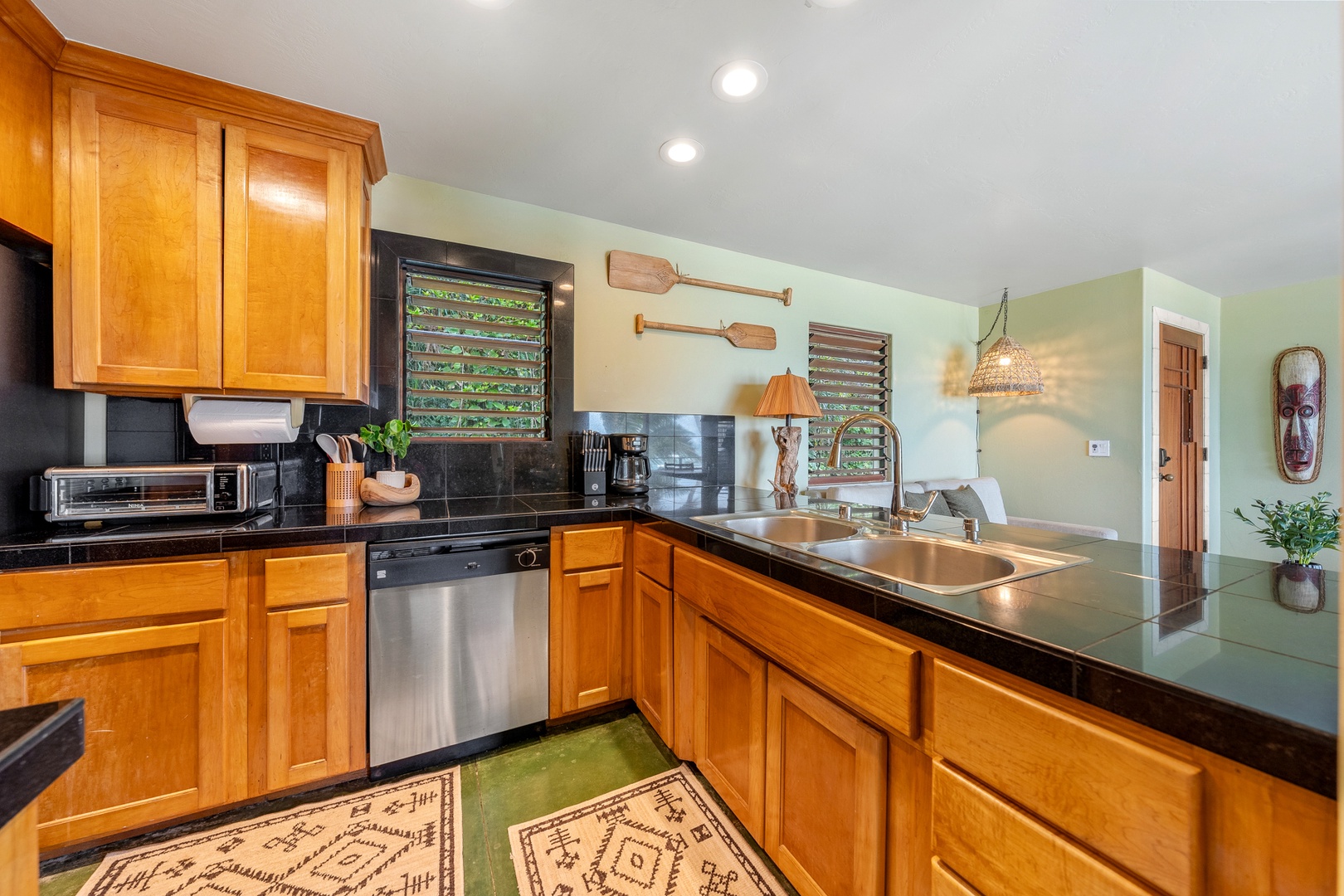 Hanalei Vacation Rentals, Hale Kepuhi - Your fully equipped kitchen features warm wood cabinets for preparing tropical meals together.