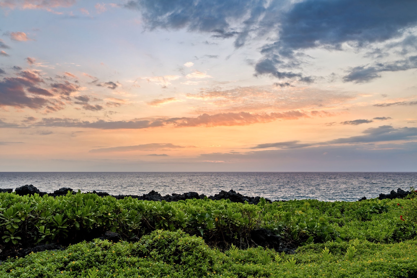 Kailua Kona Vacation Rentals, Keauhou Kona Surf & Racquet 1104 - Green in the foreground, color in the sky, and the water going quiet at dusk.