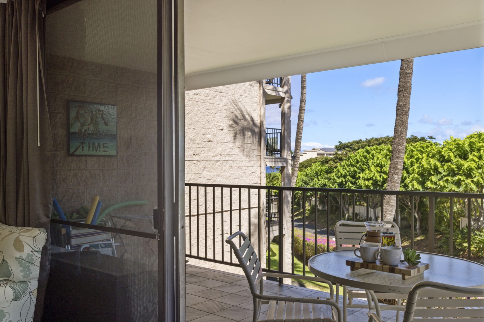 Kihei Vacation Rentals, Kihei Alii Kai C206 - Step through the screen door onto the shaded lanai, palms leaning in on both sides.