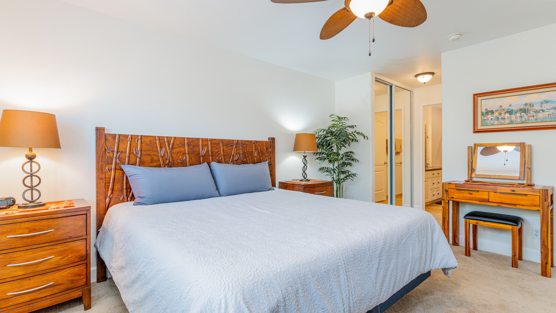 Kapolei Vacation Rentals, Ko Olina Kai 1057B - The primary guest bedroom featuring a dresser and TV.
