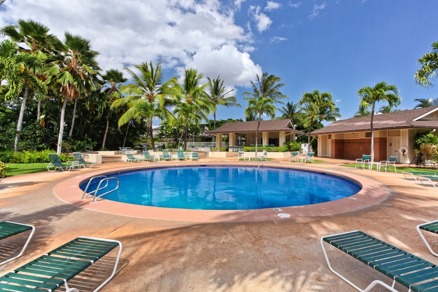 Kapolei Vacation Rentals, Fairways at Ko Olina 7A - Sparkling pool surrounded by swaying palms and comfortable loungers under tropical skies.