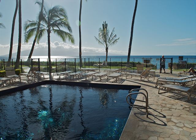 Lahaina Vacation Rentals, Mahana 1118 - Relax by the pool with breathtaking ocean views just steps away. Enjoy the tropical ambiance and unwind in the sun, perfect for a serene and refreshing getaway.